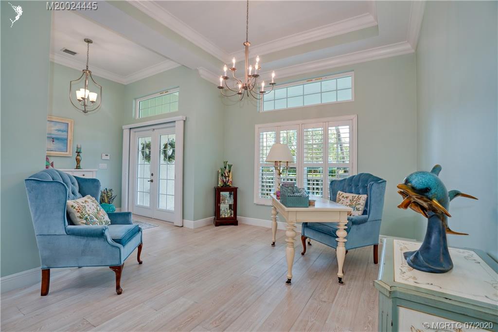 2198 Southwest Mainsail Terrace Stuart, FL 34997 - Photo 22 of 68 a living room with furniture and a chandelier