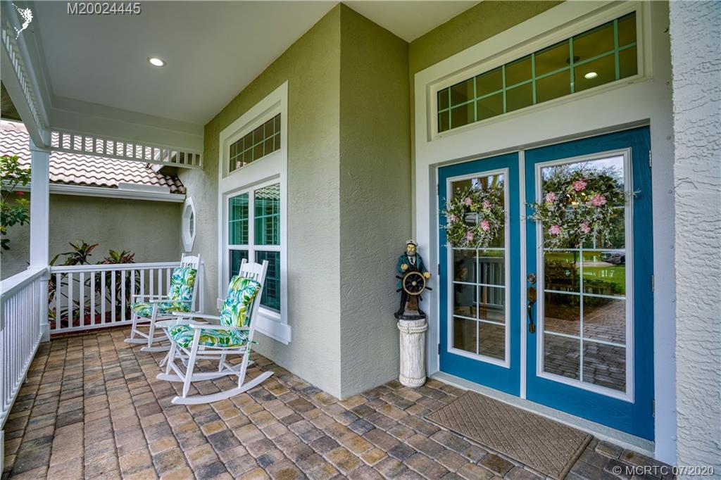 2198 Southwest Mainsail Terrace Stuart, FL 34997 - Photo 28 of 68 a view of a porch with a table and chairs