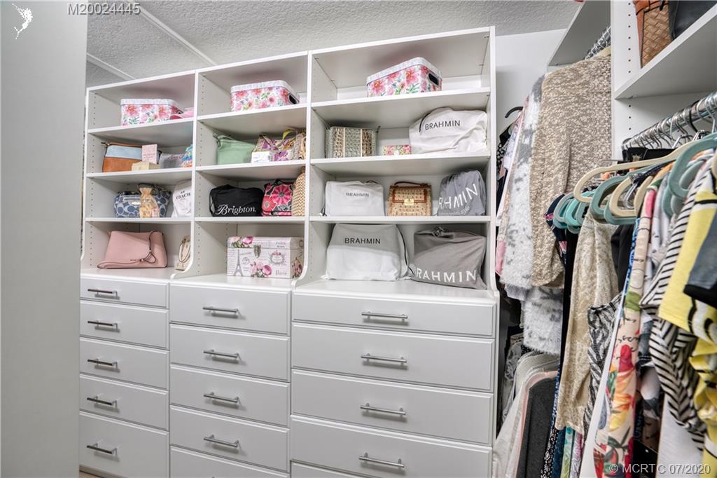 2198 Southwest Mainsail Terrace Stuart, FL 34997 - Photo 30 of 68 a view of walk in closet with clothes and shoes