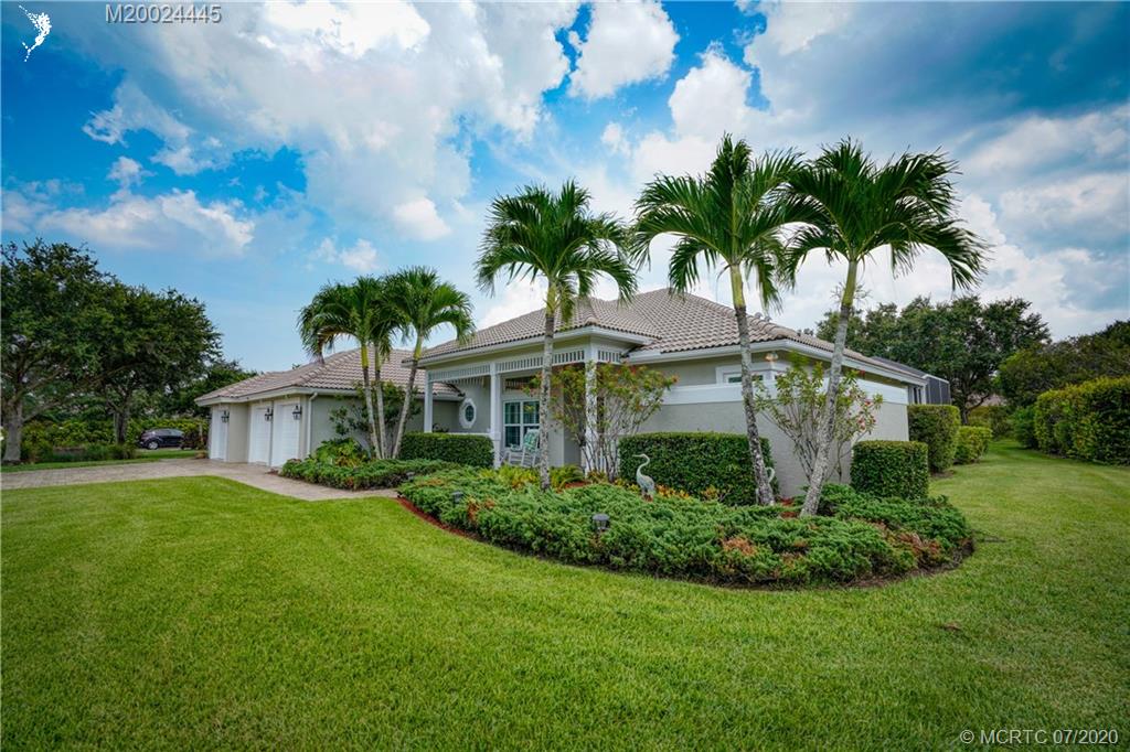 2198 Southwest Mainsail Terrace Stuart, FL 34997 - Photo 3 of 68 a front view of a house with a garden