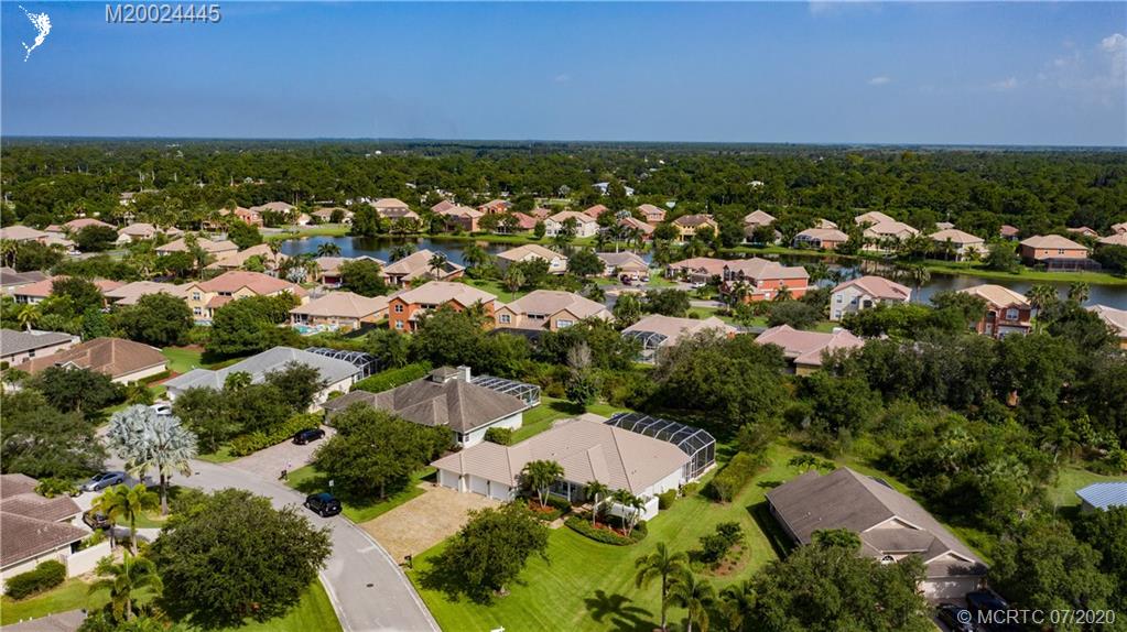 2198 Southwest Mainsail Terrace Stuart, FL 34997 - Photo 32 of 68 an aerial view of residential houses with outdoor space and trees