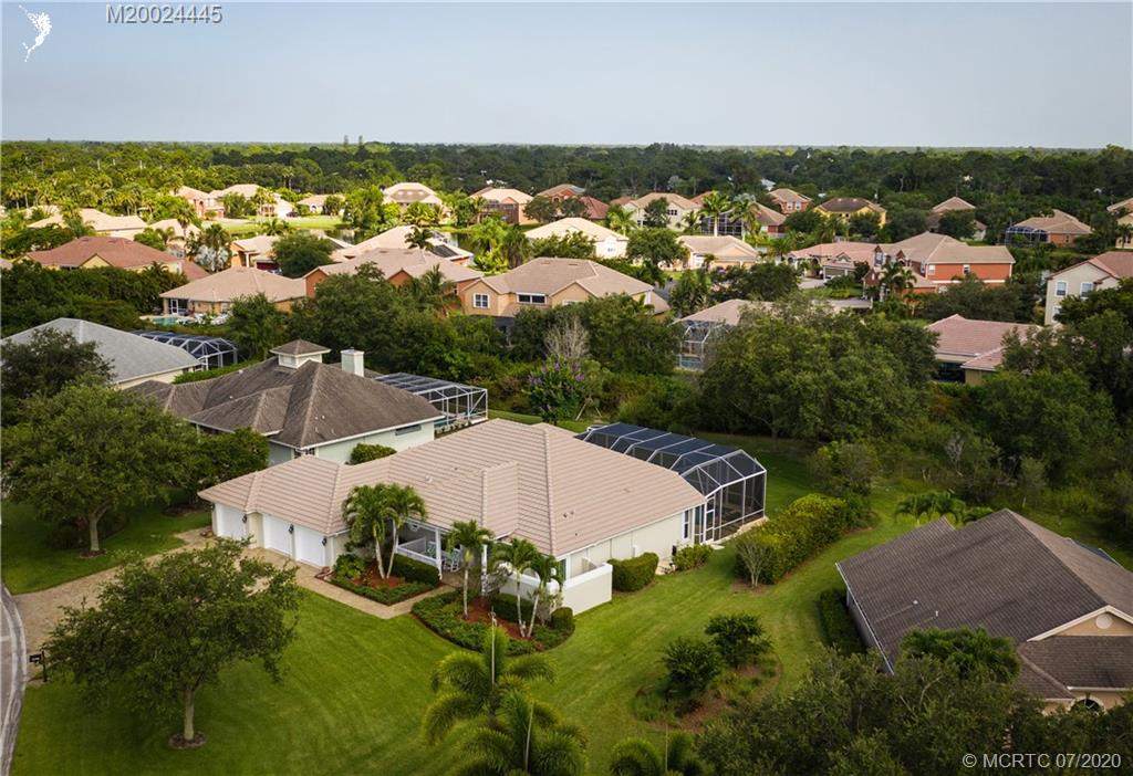 2198 Southwest Mainsail Terrace Stuart, FL 34997 - Photo 4 of 68 an aerial view of residential houses with outdoor space and trees