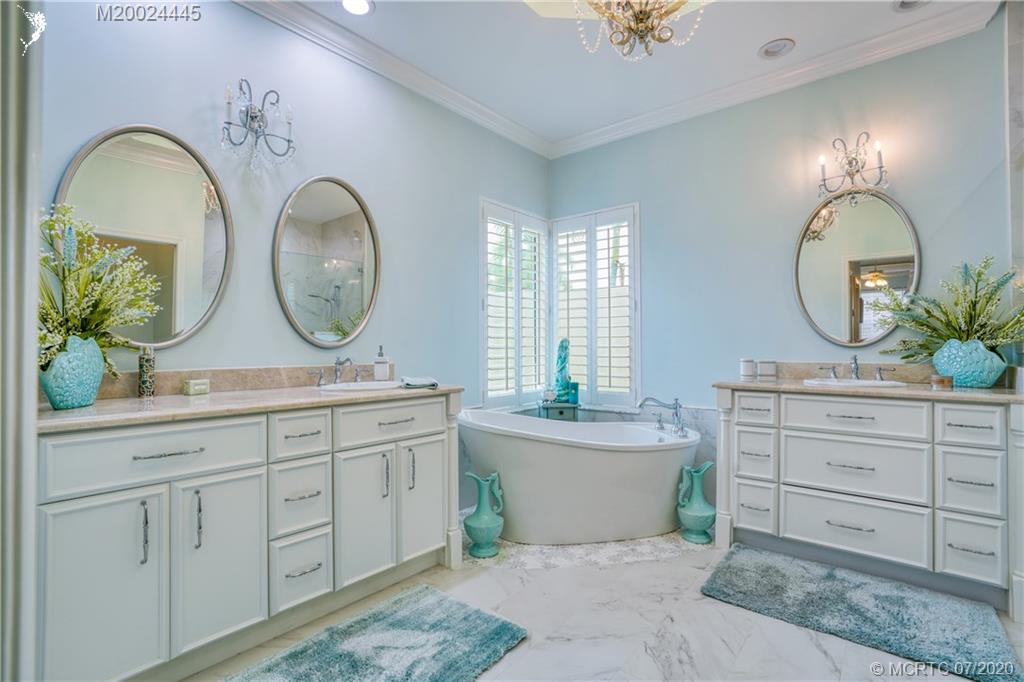 2198 Southwest Mainsail Terrace Stuart, FL 34997 - Photo 42 of 68 a bathroom with a double vanity sink and a mirror