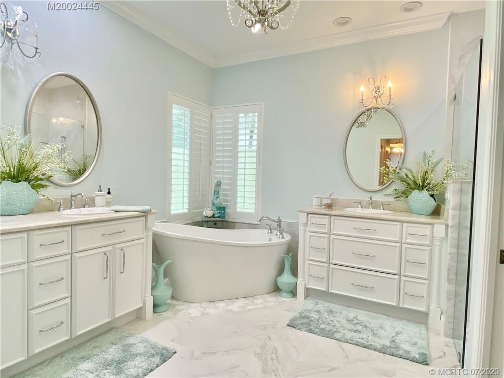 2198 Southwest Mainsail Terrace Stuart, FL 34997 - Photo 43 of 68 a spacious bathroom with a double vanity sink and a mirror