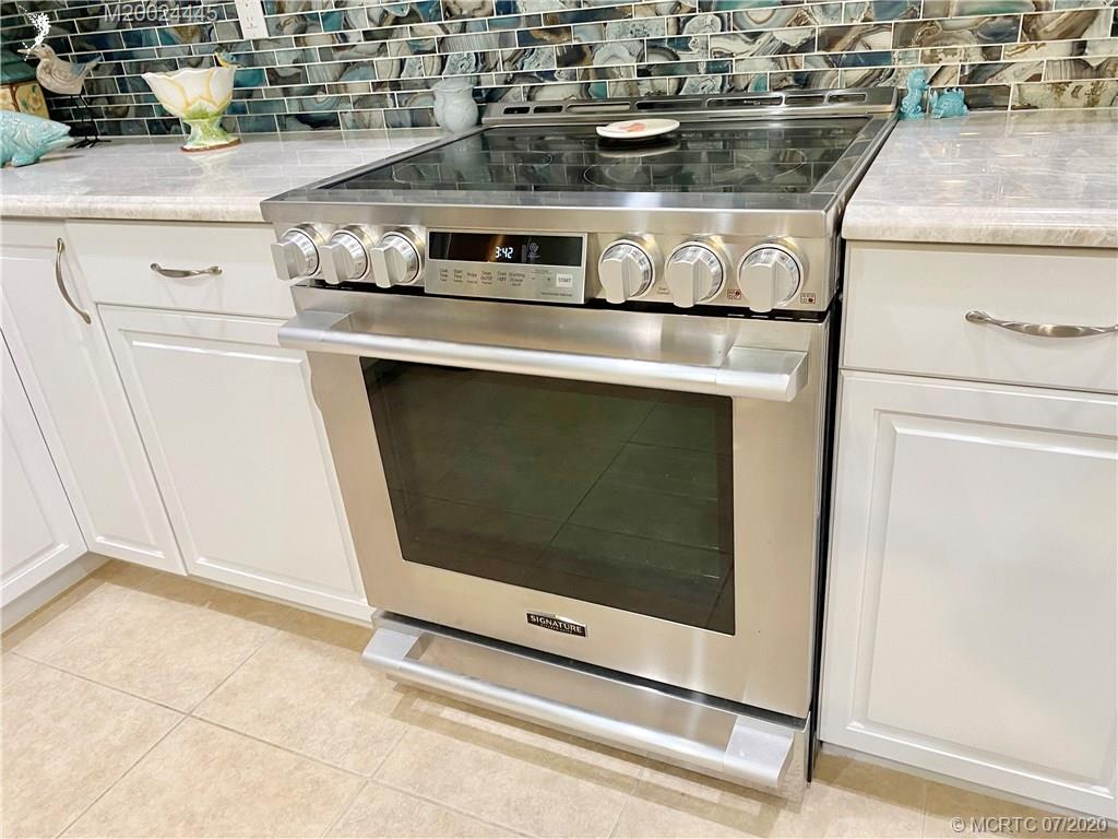 2198 Southwest Mainsail Terrace Stuart, FL 34997 - Photo 45 of 68 a stove top oven sitting inside of a kitchen