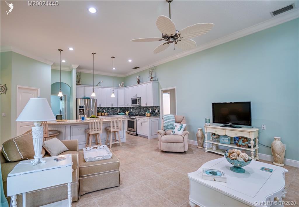 2198 Southwest Mainsail Terrace Stuart, FL 34997 - Photo 54 of 68 a living room with furniture and a flat screen tv