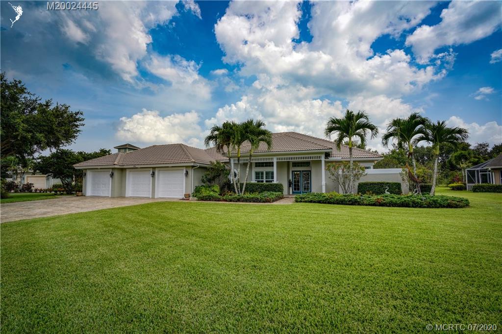 2198 Southwest Mainsail Terrace Stuart, FL 34997 - Photo 63 of 68 a front view of a house with garden