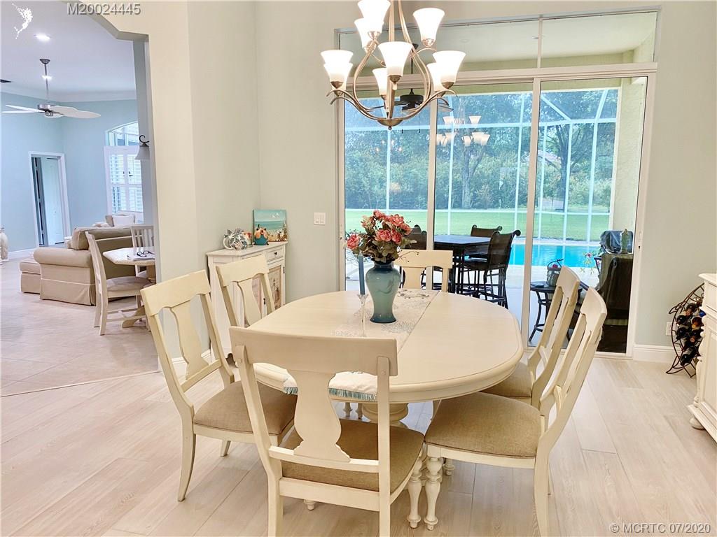 2198 Southwest Mainsail Terrace Stuart, FL 34997 - Photo 66 of 68 a view of a dining room with furniture wooden floor and chandelier