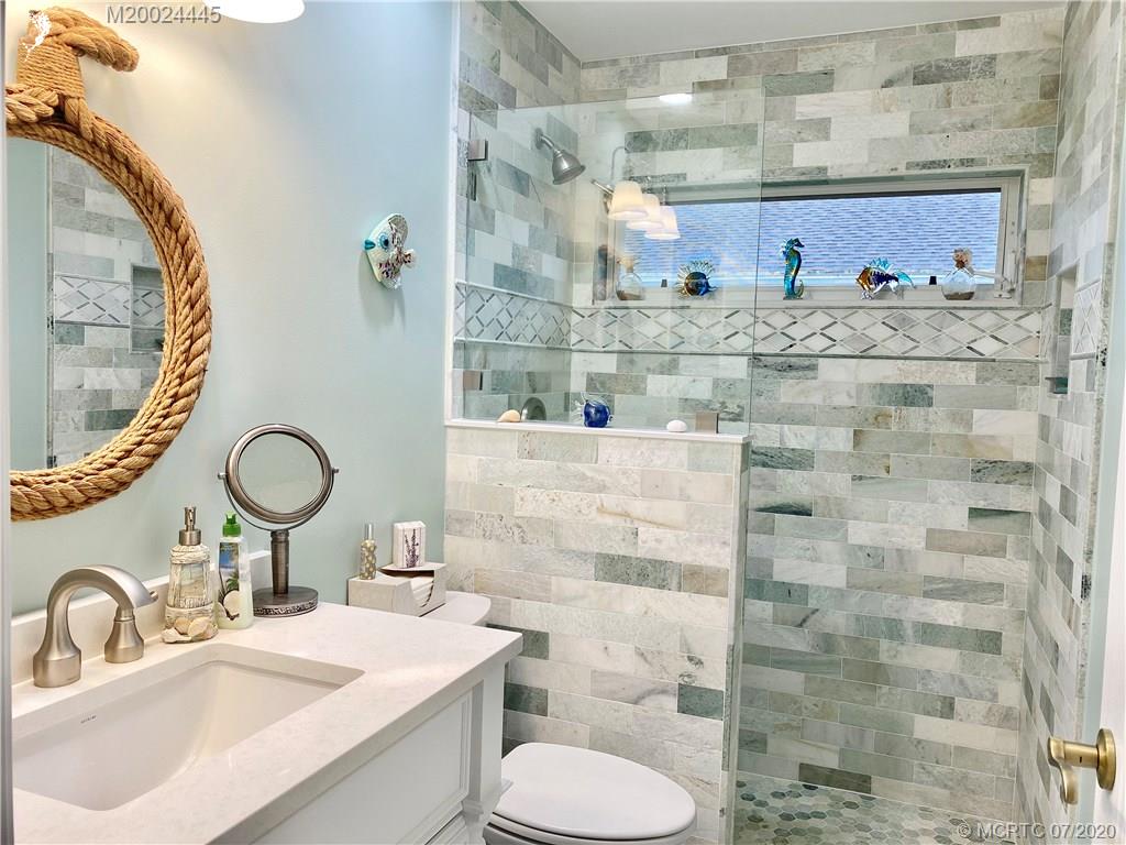 2198 Southwest Mainsail Terrace Stuart, FL 34997 - Photo 67 of 68 a bathroom with a sink mirror toilet and shower