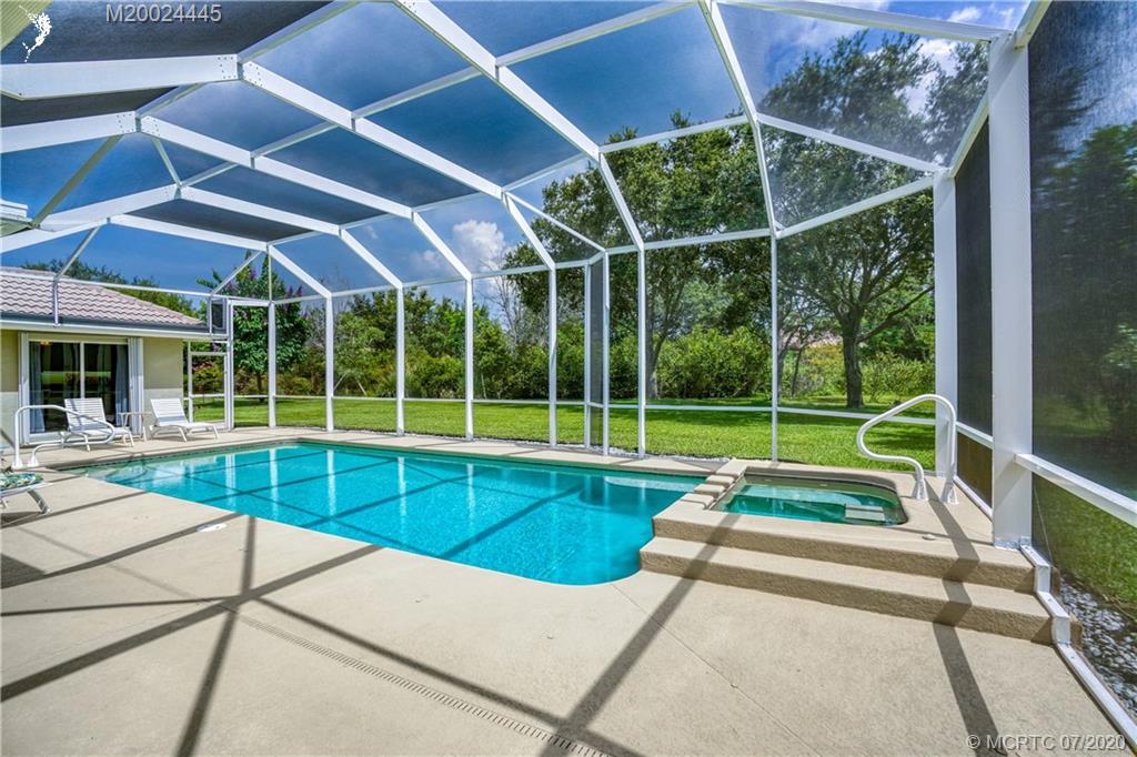 2198 Southwest Mainsail Terrace Stuart, FL 34997 - Photo 7 of 68 a view of a backyard with a swimming pool