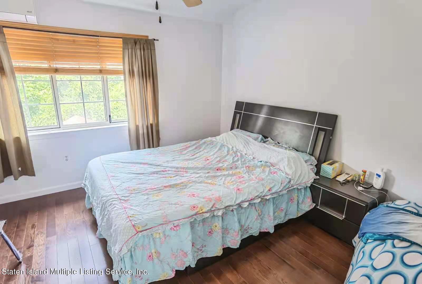 44 Chesebrough Street Staten Island, NY 10312 - Photo 11 of 24 a bedroom with a bed and wooden floor