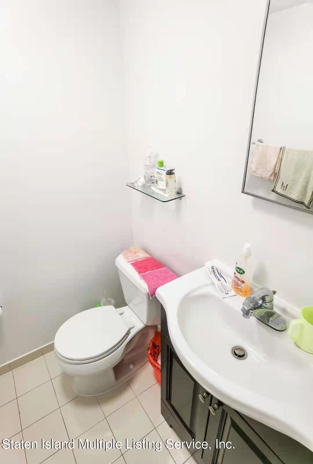 44 Chesebrough Street Staten Island, NY 10312 - Photo 12 of 24 a bathroom with a sink a toilet and a mirror