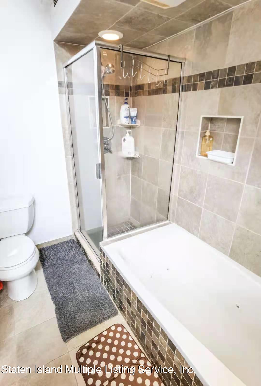 44 Chesebrough Street Staten Island, NY 10312 - Photo 13 of 24 a bathroom with a granite countertop shower and toilet