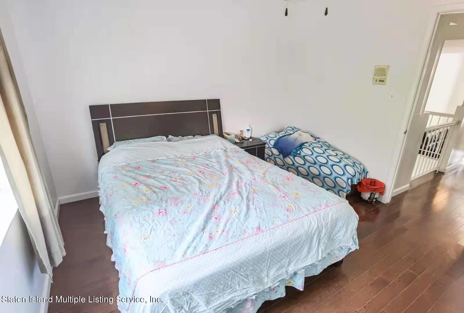 44 Chesebrough Street Staten Island, NY 10312 - Photo 17 of 24 a bedroom with a bed and hardwood floor
