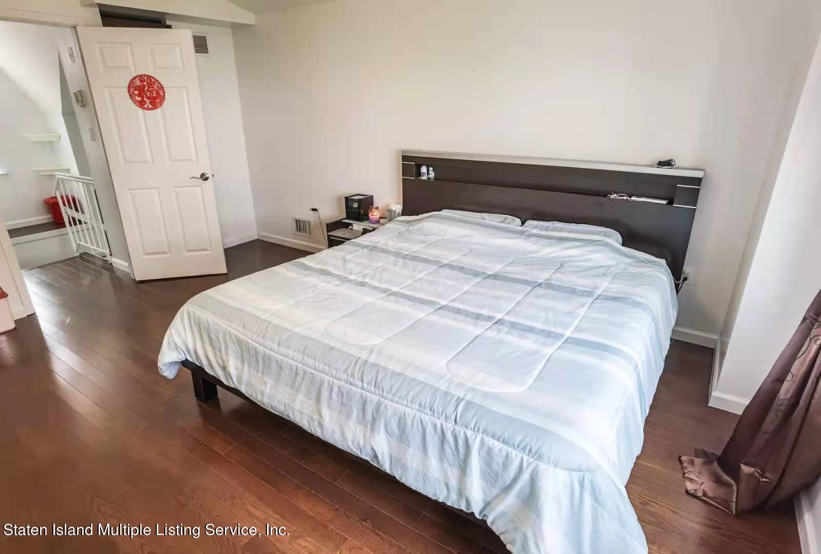 44 Chesebrough Street Staten Island, NY 10312 - Photo 21 of 24 a bedroom with a bed and wooden floor