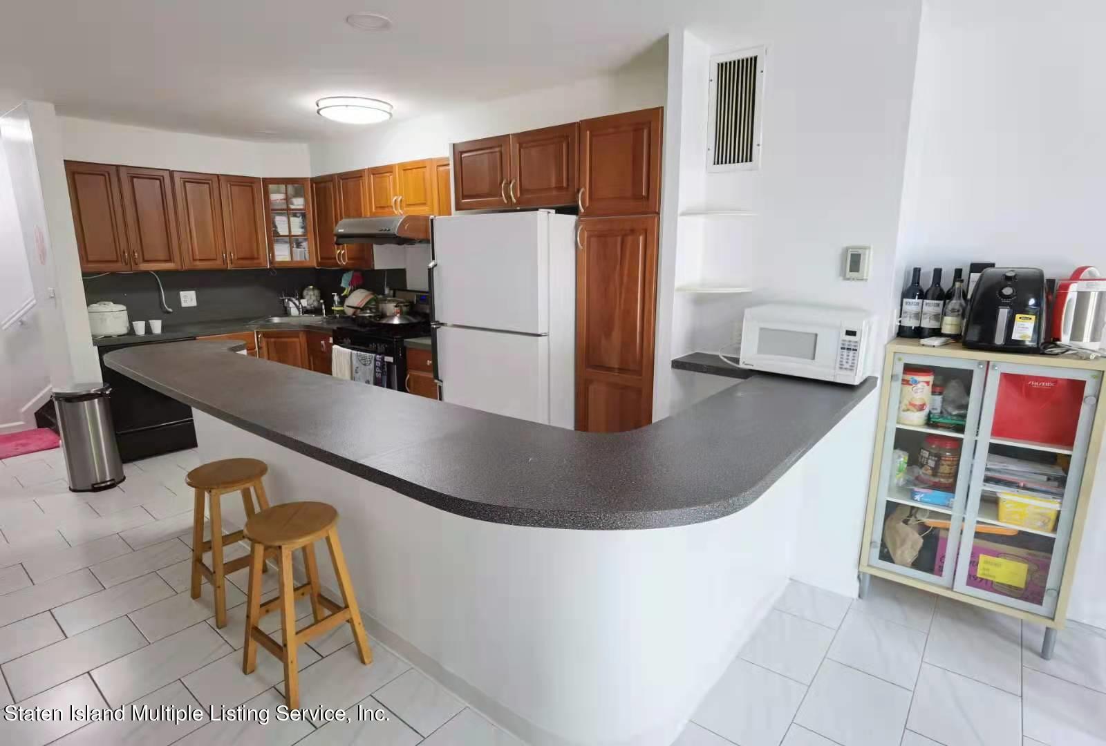 44 Chesebrough Street Staten Island, NY 10312 - Photo 4 of 24 a kitchen with refrigerator and cabinets