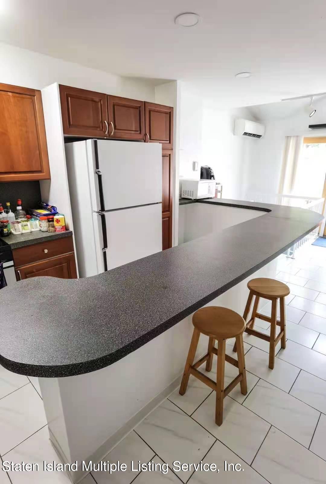 44 Chesebrough Street Staten Island, NY 10312 - Photo 5 of 24 a kitchen with furniture and a refrigerator