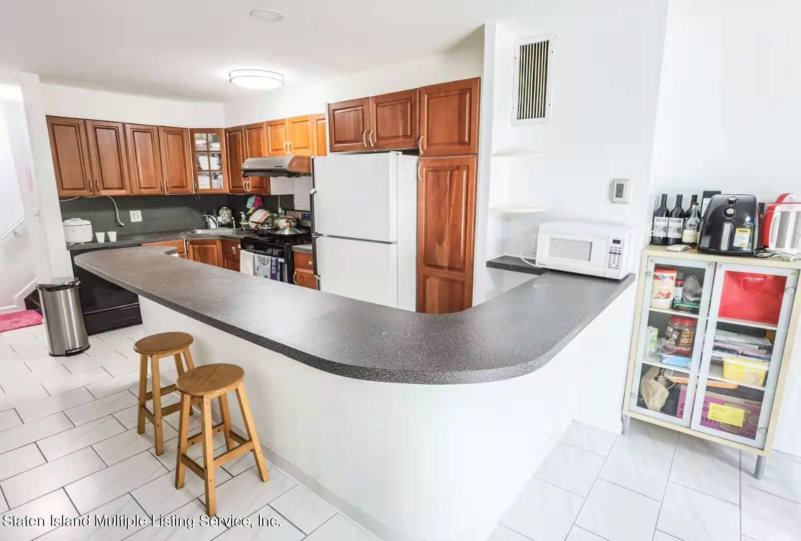 44 Chesebrough Street Staten Island, NY 10312 - Photo 6 of 24 a kitchen with stainless steel appliances granite countertop a sink a stove and a refrigerator