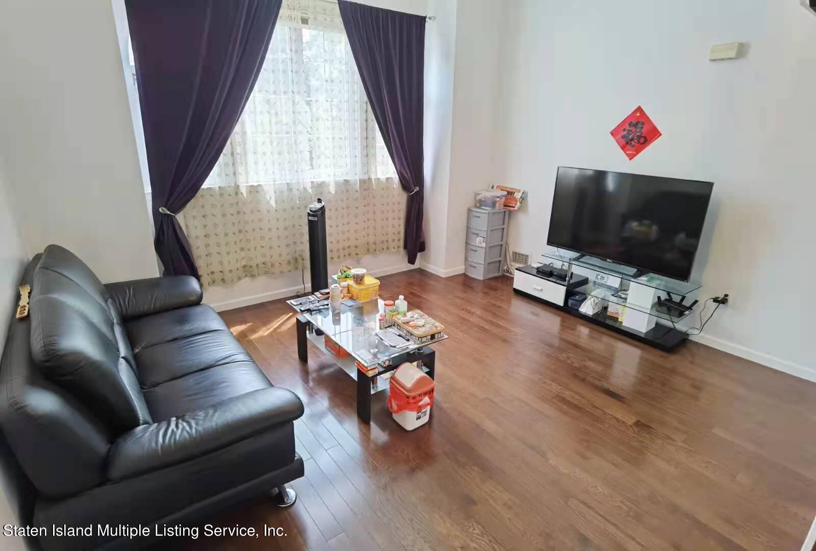 44 Chesebrough Street Staten Island, NY 10312 - Photo 7 of 24 a living room with furniture and a flat screen tv