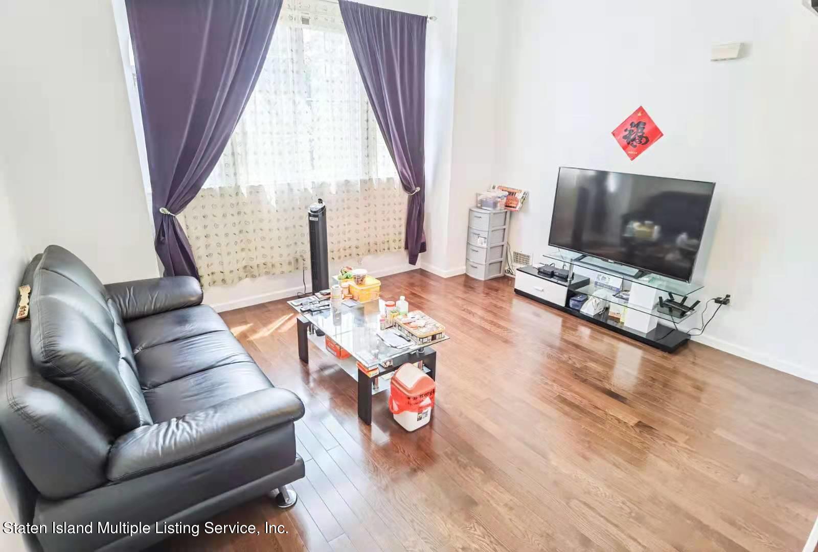 44 Chesebrough Street Staten Island, NY 10312 - Photo 9 of 24 a living room with furniture a flat screen tv and a window