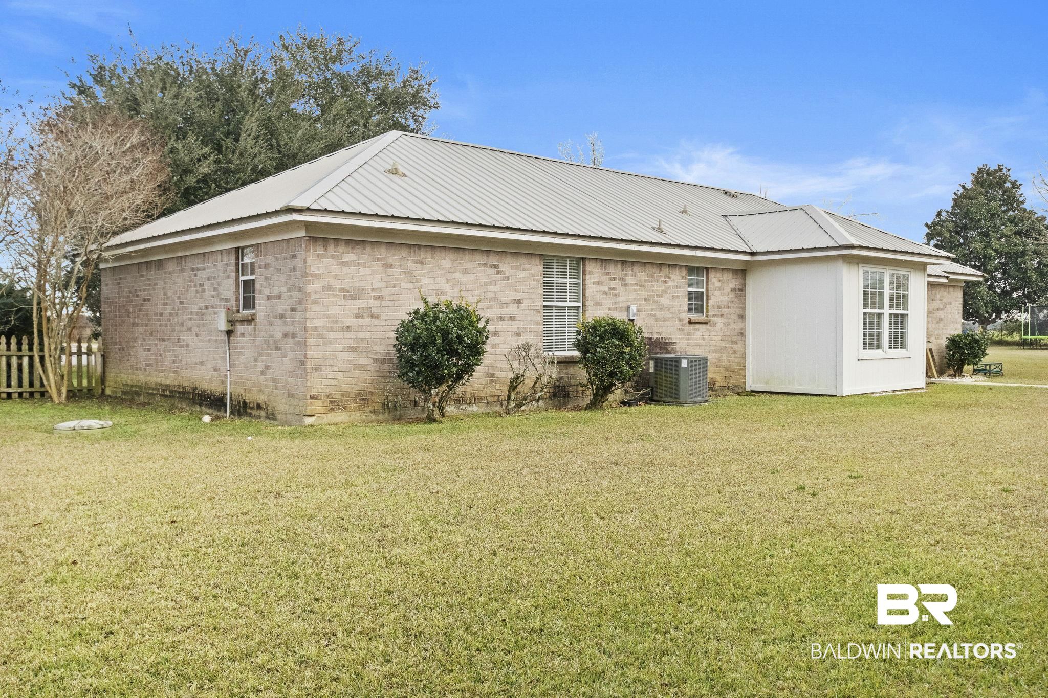 14031 Brook Hollow Road Summerdale, AL 36580 - Photo 49 of 56 Back of house featuring central AC and a lawn