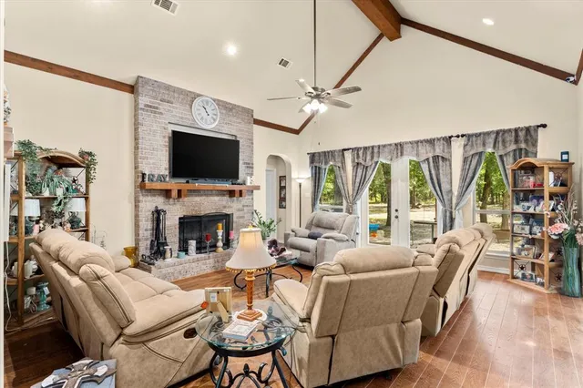 a living room with fireplace furniture and a flat screen tv