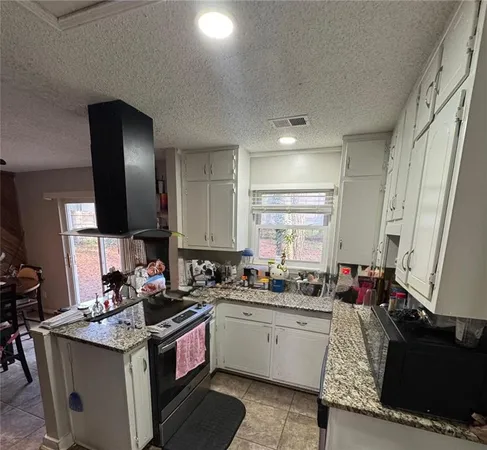 a kitchen with a sink stove and cabinets