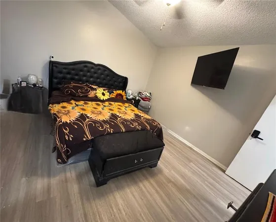a bedroom with a bed and flat screen tv