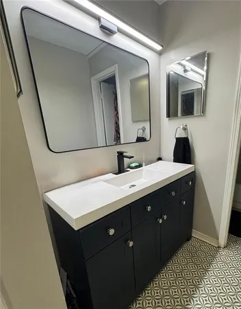 a bathroom with a sink a mirror and vanity