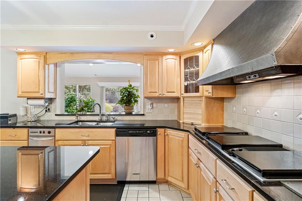 46 Cheslock Road Canonsburg, PA 15317 - Photo 4 of 24 a kitchen with granite countertop a sink stainless steel appliances white cabinets and a window