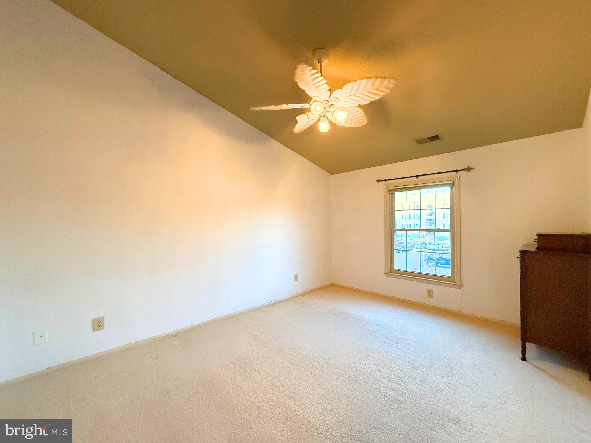 10706 Kings Riding Way, Unit 20118 Rockville, MD 20852 - Photo 14 of 24 a view of an empty room with chandelier fan and a window
