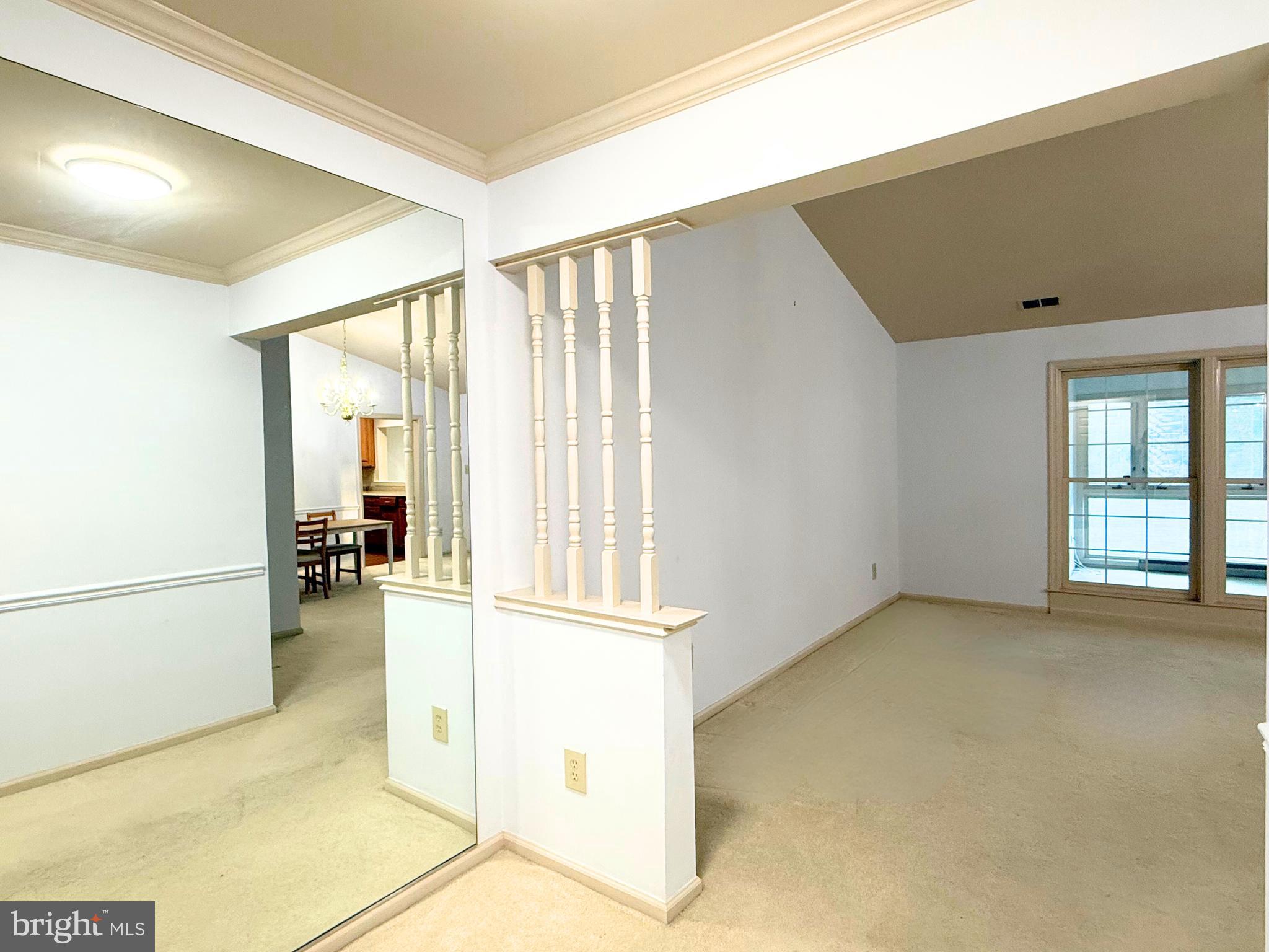 10706 Kings Riding Way, Unit 20118 Rockville, MD 20852 - Photo 3 of 24 a view of empty room with wooden floor and cabinet