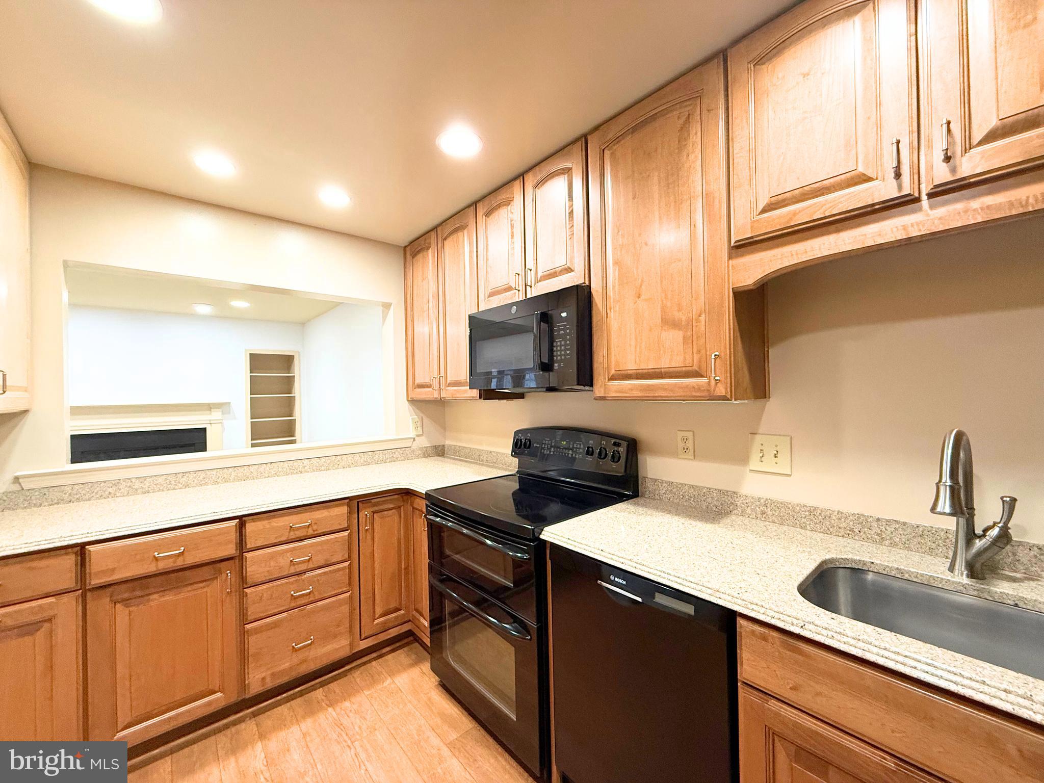 10706 Kings Riding Way, Unit 20118 Rockville, MD 20852 - Photo 6 of 24 a kitchen with stainless steel appliances granite countertop a sink and a stove