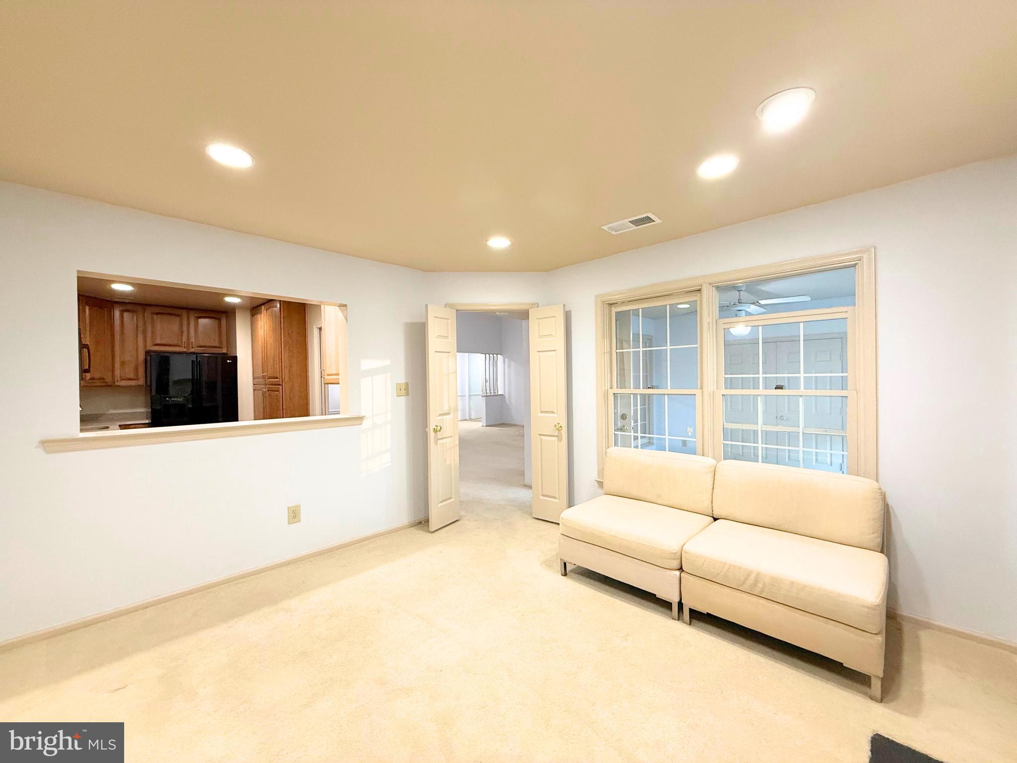 10706 Kings Riding Way, Unit 20118 Rockville, MD 20852 - Photo 10 of 24 a spacious bedroom with a large bed and a large window