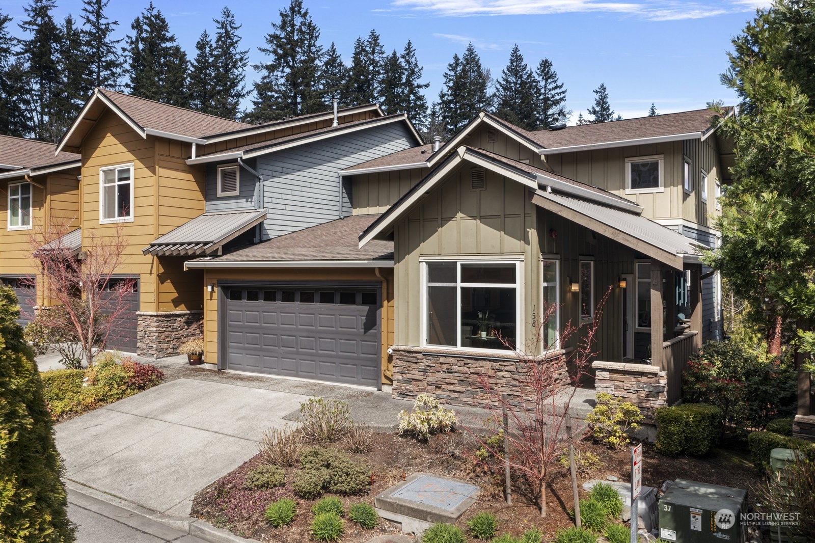 158 Cougar Ridge Road Northwest Issaquah, WA 98027 - Photo 1 of 39 a front view of a house with a yard and garage