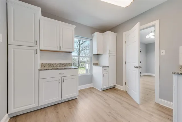 a kitchen with a refrigerator sink and cabinets