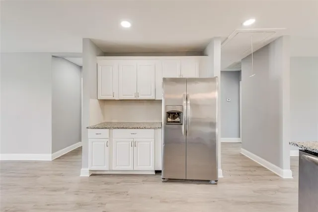 a kitchen with stainless steel appliances a refrigerator and a stove top oven