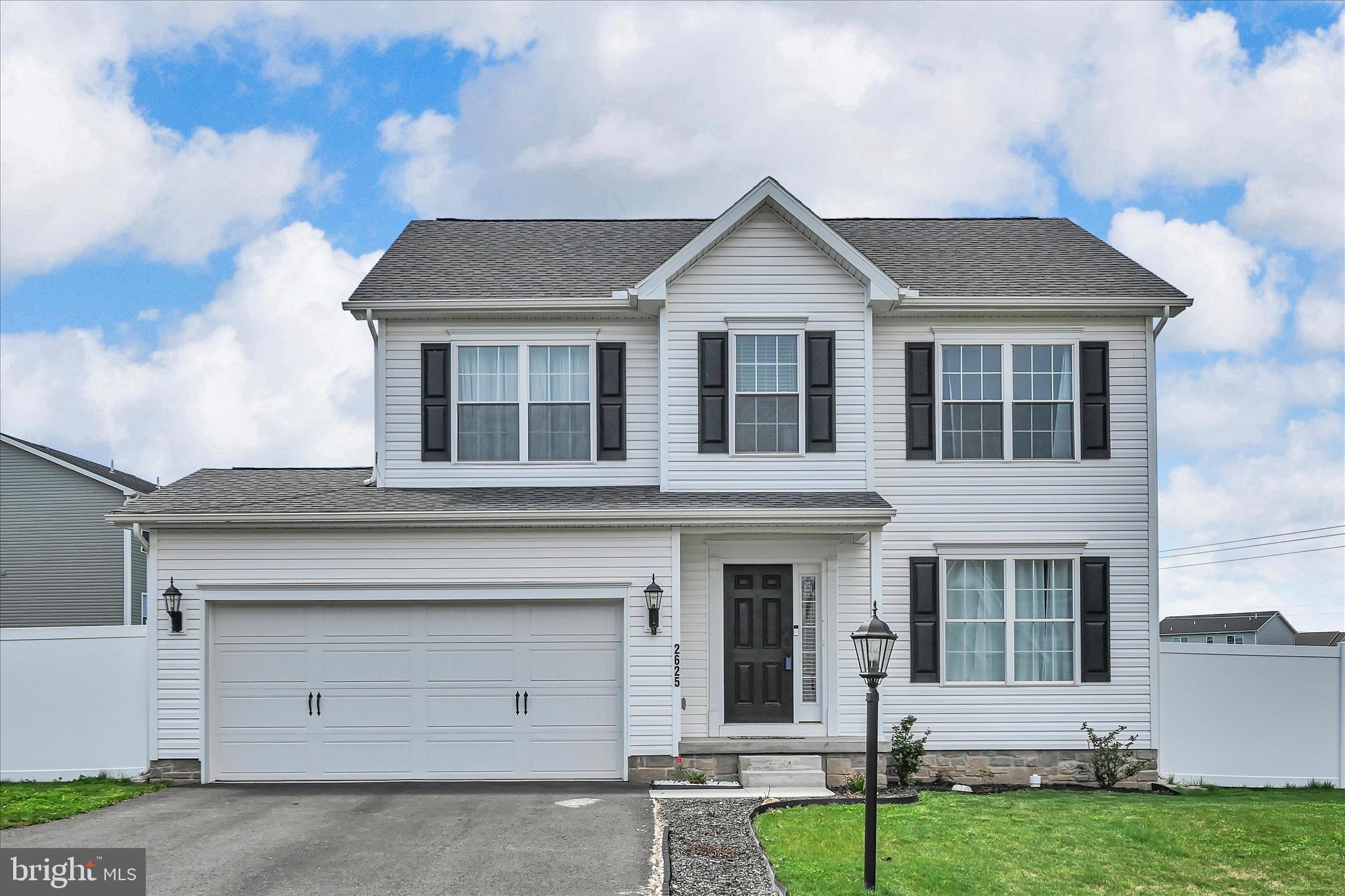 2625 Village Road Dover, PA 17315 - Photo 1 of 15 a front view of a house with a yard and garage