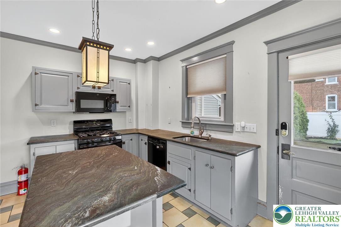 1036 Maple Street Bethlehem, PA 18018 - Photo 17 of 48 a kitchen with stainless steel appliances granite countertop a sink stove and refrigerator