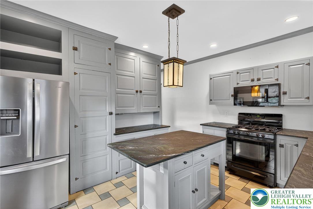 1036 Maple Street Bethlehem, PA 18018 - Photo 18 of 48 a kitchen with stainless steel appliances granite countertop a sink a stove and a refrigerator