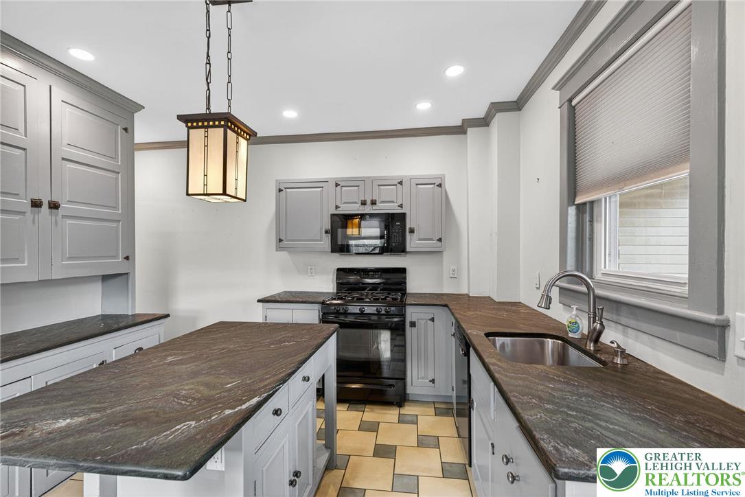 1036 Maple Street Bethlehem, PA 18018 - Photo 19 of 48 a kitchen with granite countertop a stove a sink and a refrigerator