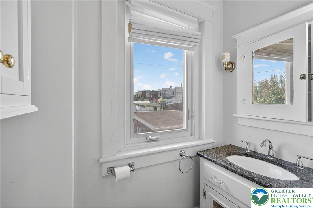 1036 Maple Street Bethlehem, PA 18018 - Photo 29 of 48 a bathroom with a granite countertop sink mirror vanity and window