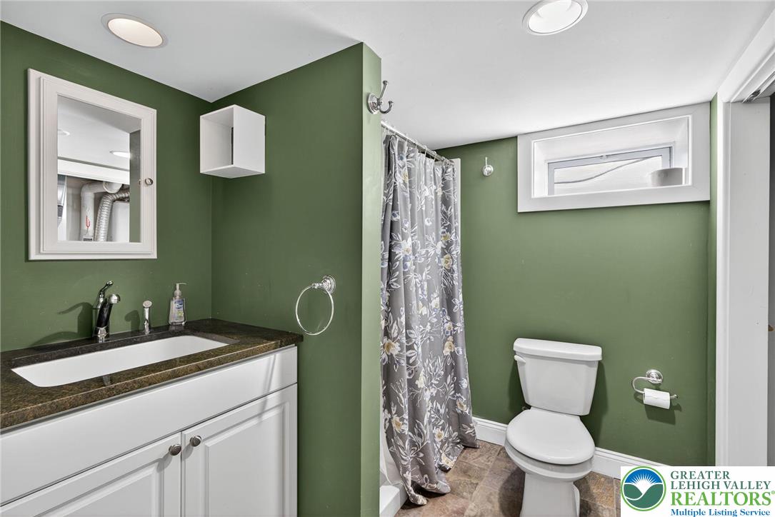 1036 Maple Street Bethlehem, PA 18018 - Photo 37 of 48 a bathroom with a toilet sink and mirror