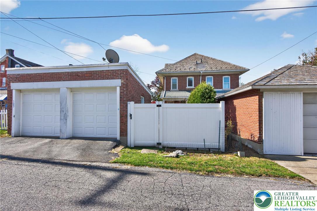 1036 Maple Street Bethlehem, PA 18018 - Photo 45 of 48 a front view of a house with a yard and garage