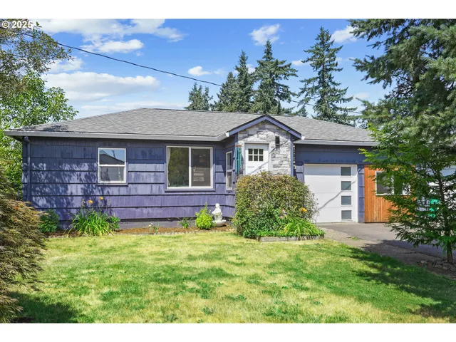 a front view of a house with a garden