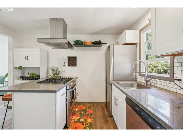 a kitchen with granite countertop a sink and a refrigerator
