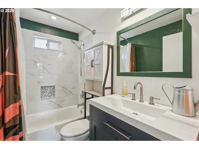 a bathroom with a sink a toilet a mirror and bathtub