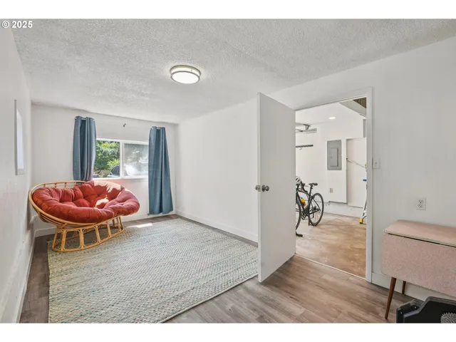 a view of a room with a table and chair and wooden floor