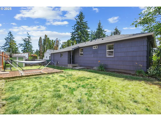a view of house with backyard space and garden