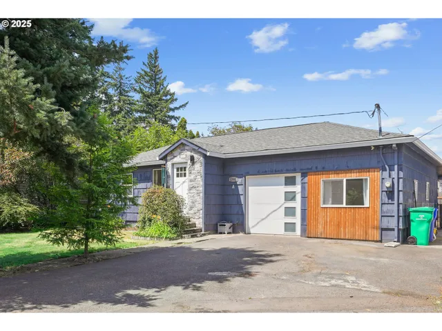 a front view of a house with a yard and a garage